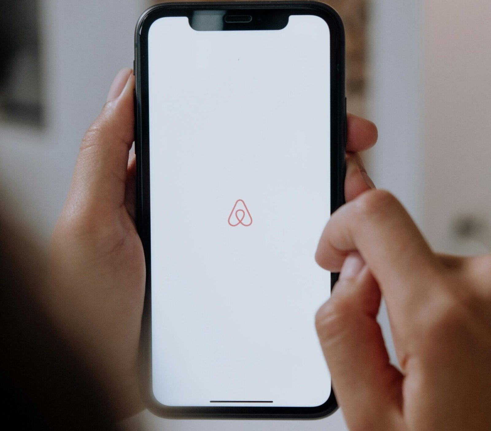 Smartphone displaying Airbnb app logo representing Bold Foundry Digital Marketing’s San Diego Airbnb listing optimization and SEO services.